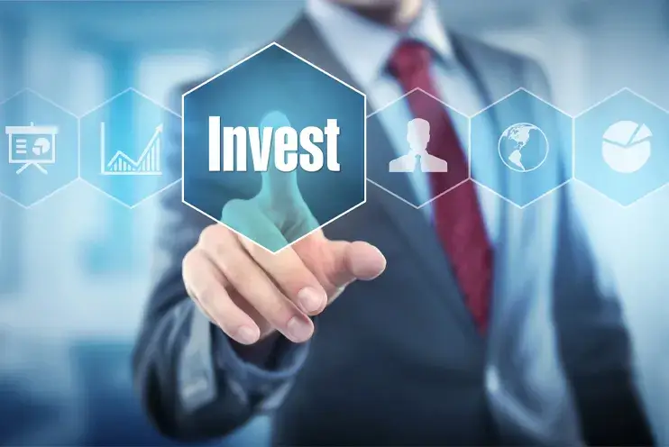 Real Estate Investment Concept – Digital Decision Making for Property Investors Businessman pressing "Invest" button on holographic interface for real estate investment.